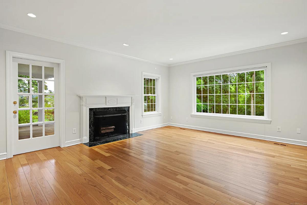 Living room with hardwood floors and a fireplace.