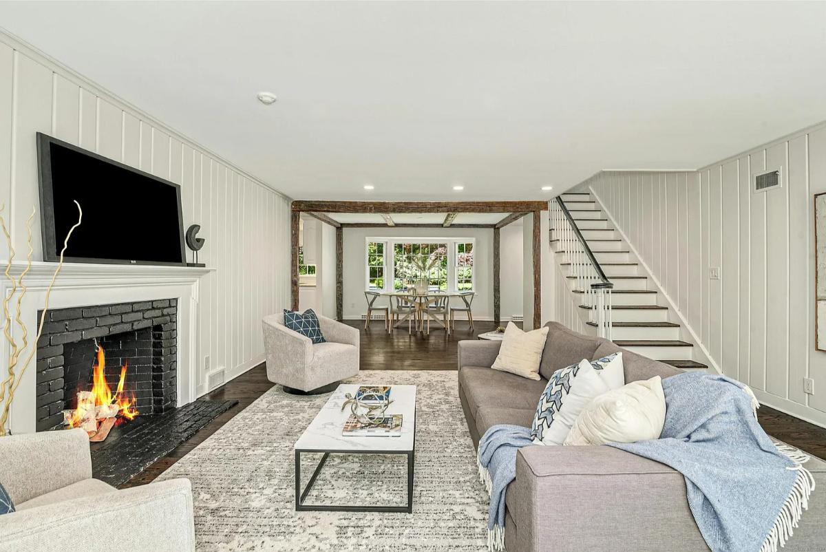 Living room with couches and a fireplace.