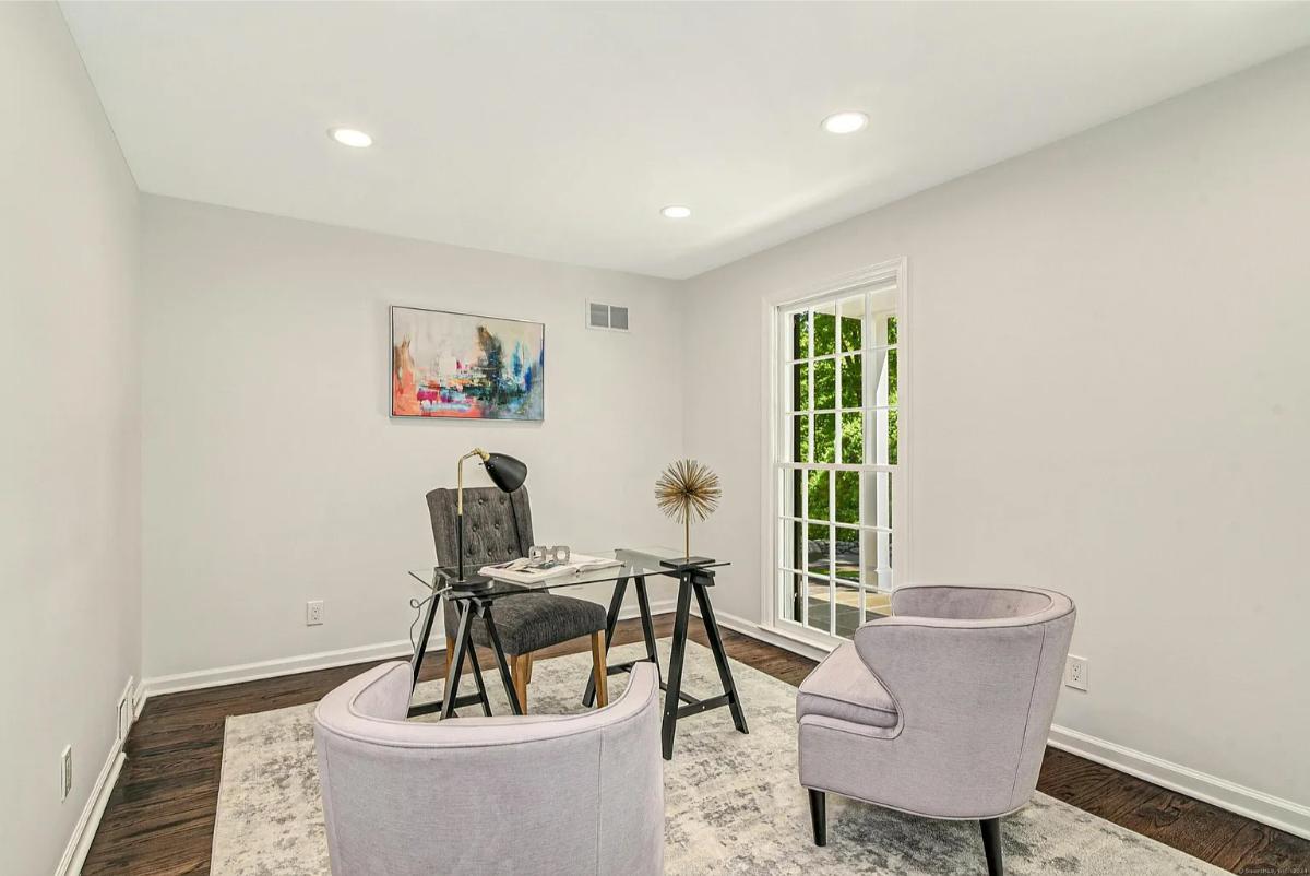 Home office with hardwood floors.