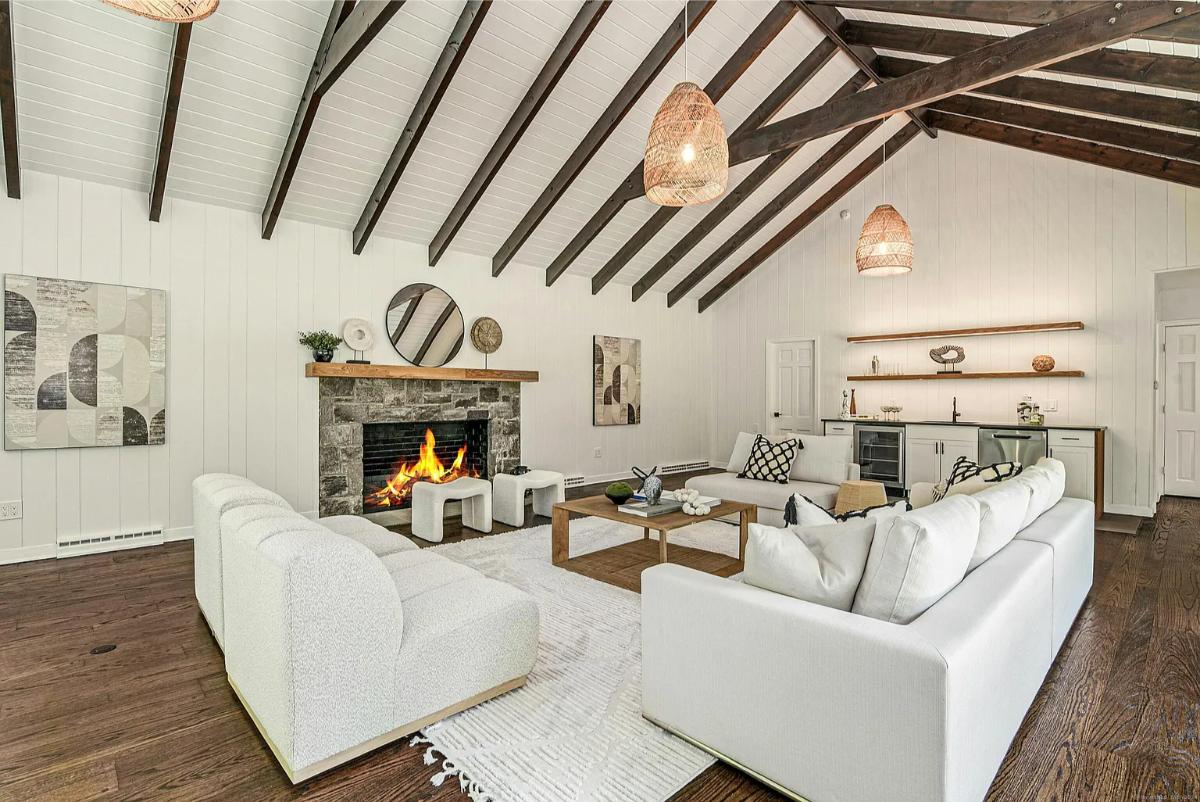 Living room with couches and a fireplace.