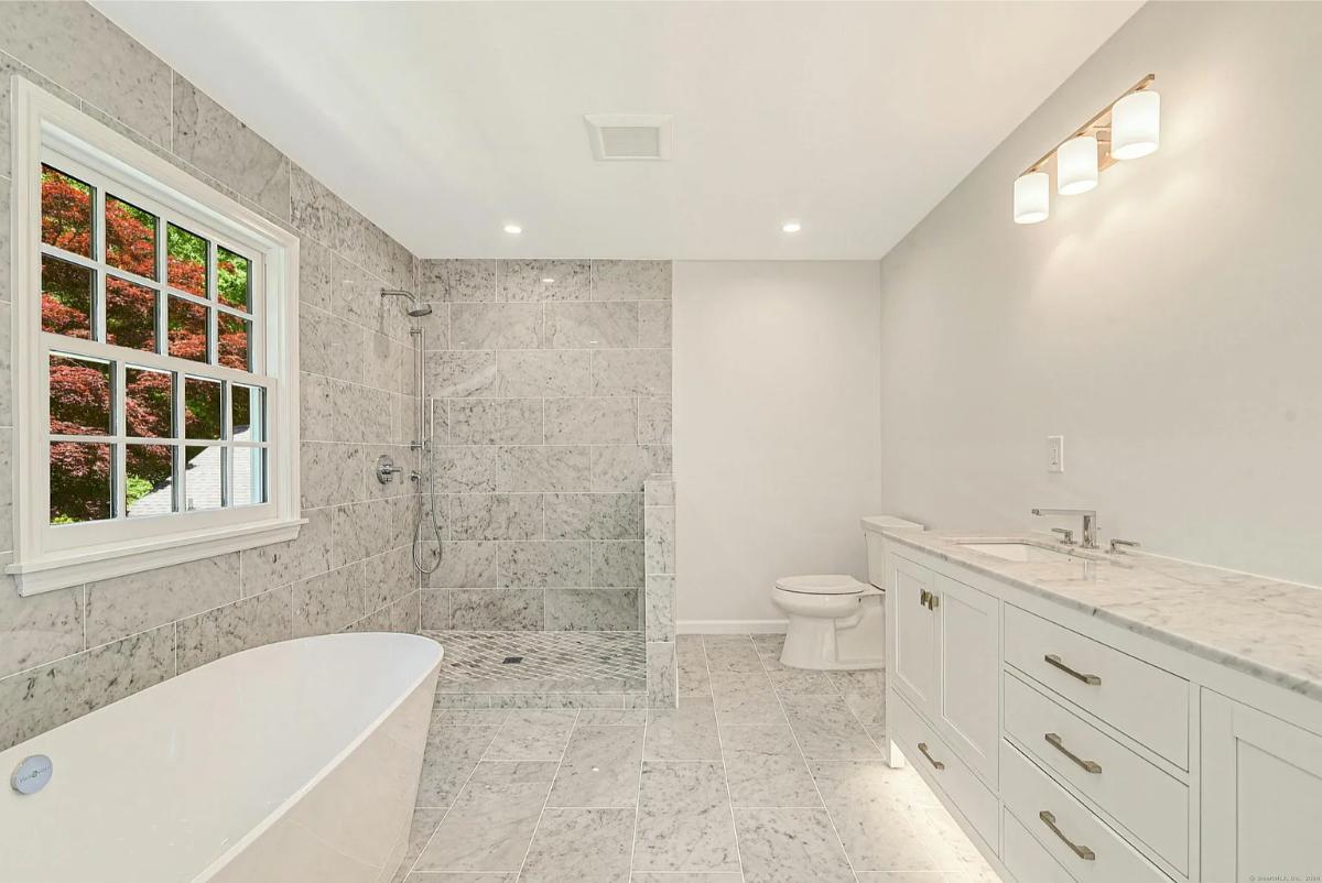 Bathroom with a sink, a soaking tub and a walk-in shower.