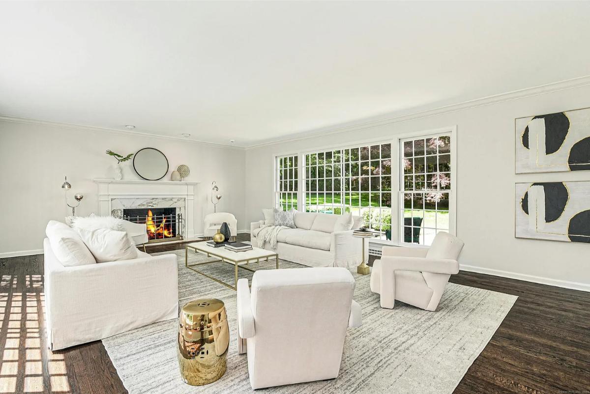 Living room with hardwood floors and a fireplace.