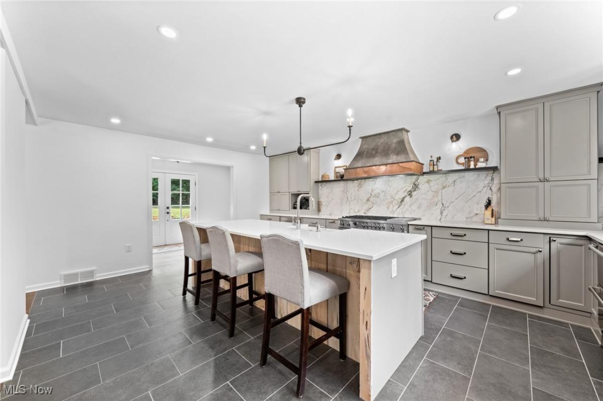 Kitchen with custom cabinetry and a counter breakfast bar.