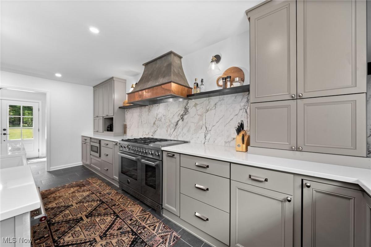 Kitchen with custom cabinetry and stainless-steel appliances.