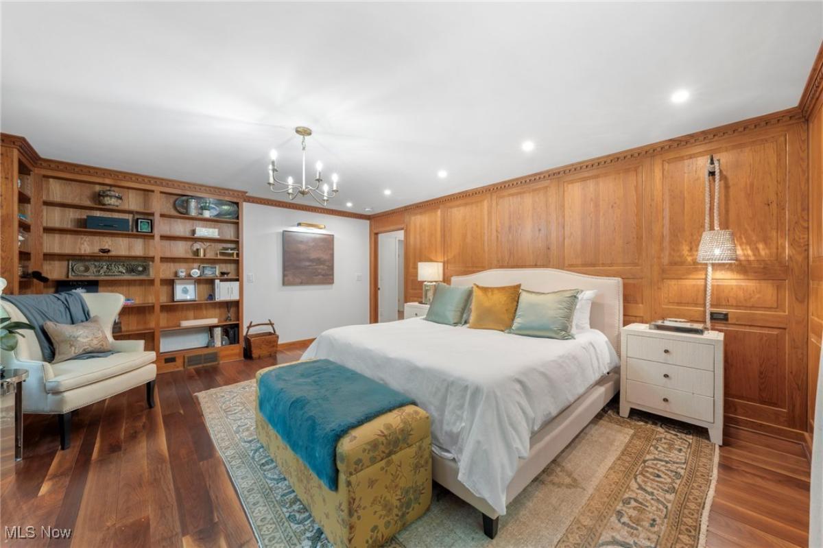 Bedroom with a large bed and hardwood floors.