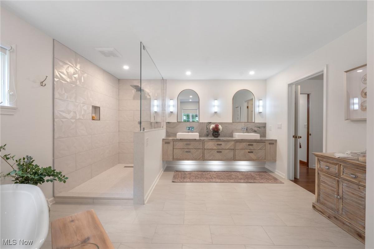Bathroom with a custom-made vanity, a soaking tub and a walk-in shower.