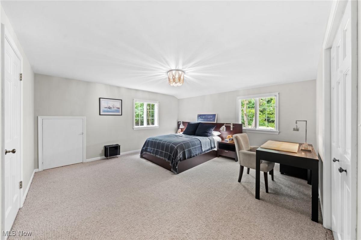 Bedroom with a large bed and carpet flooring.