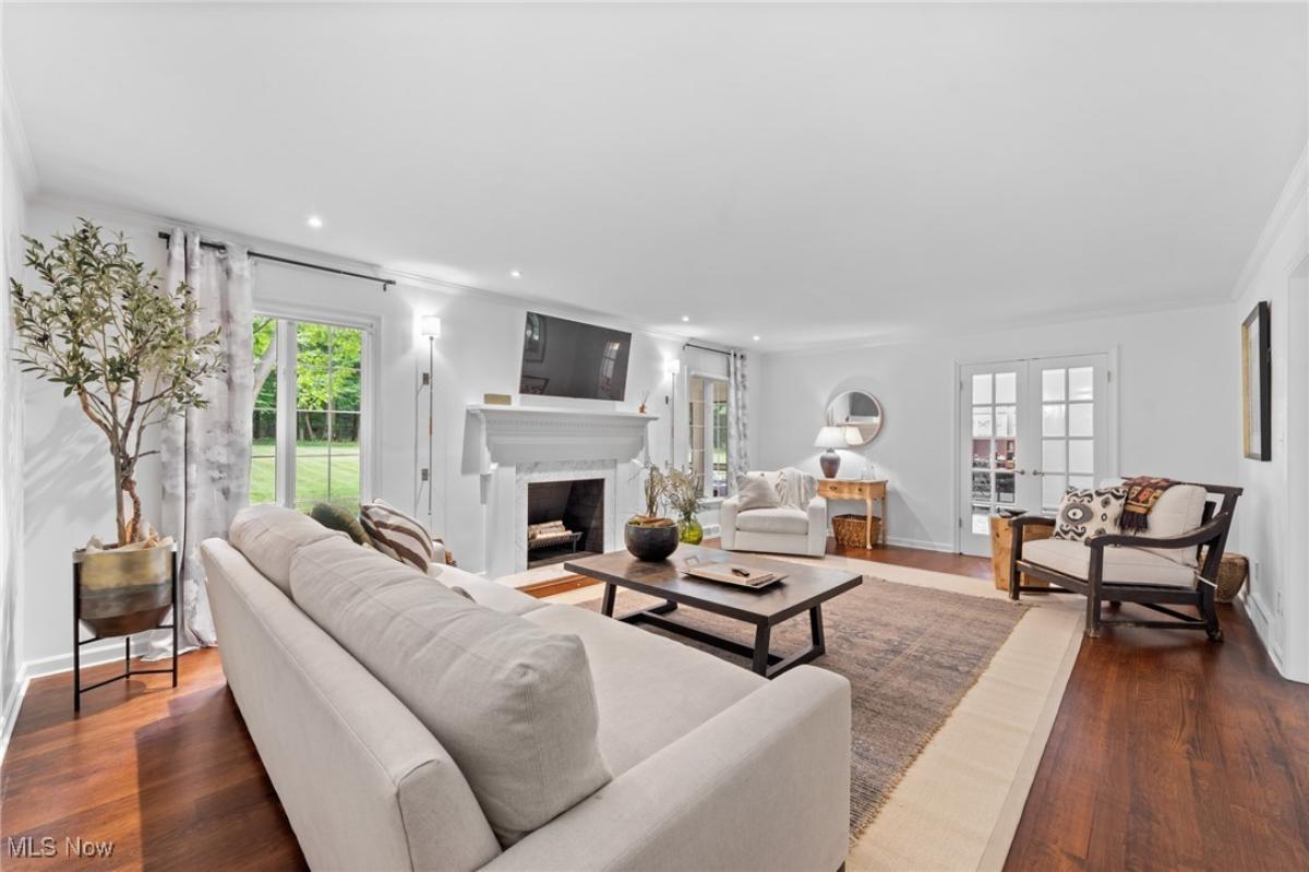 Living room with hardwood floors and a fireplace.