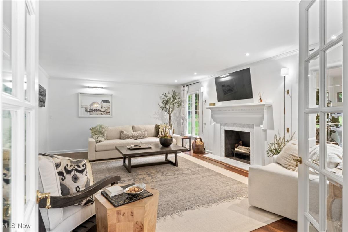 Living room with hardwood floors and a fireplace.
