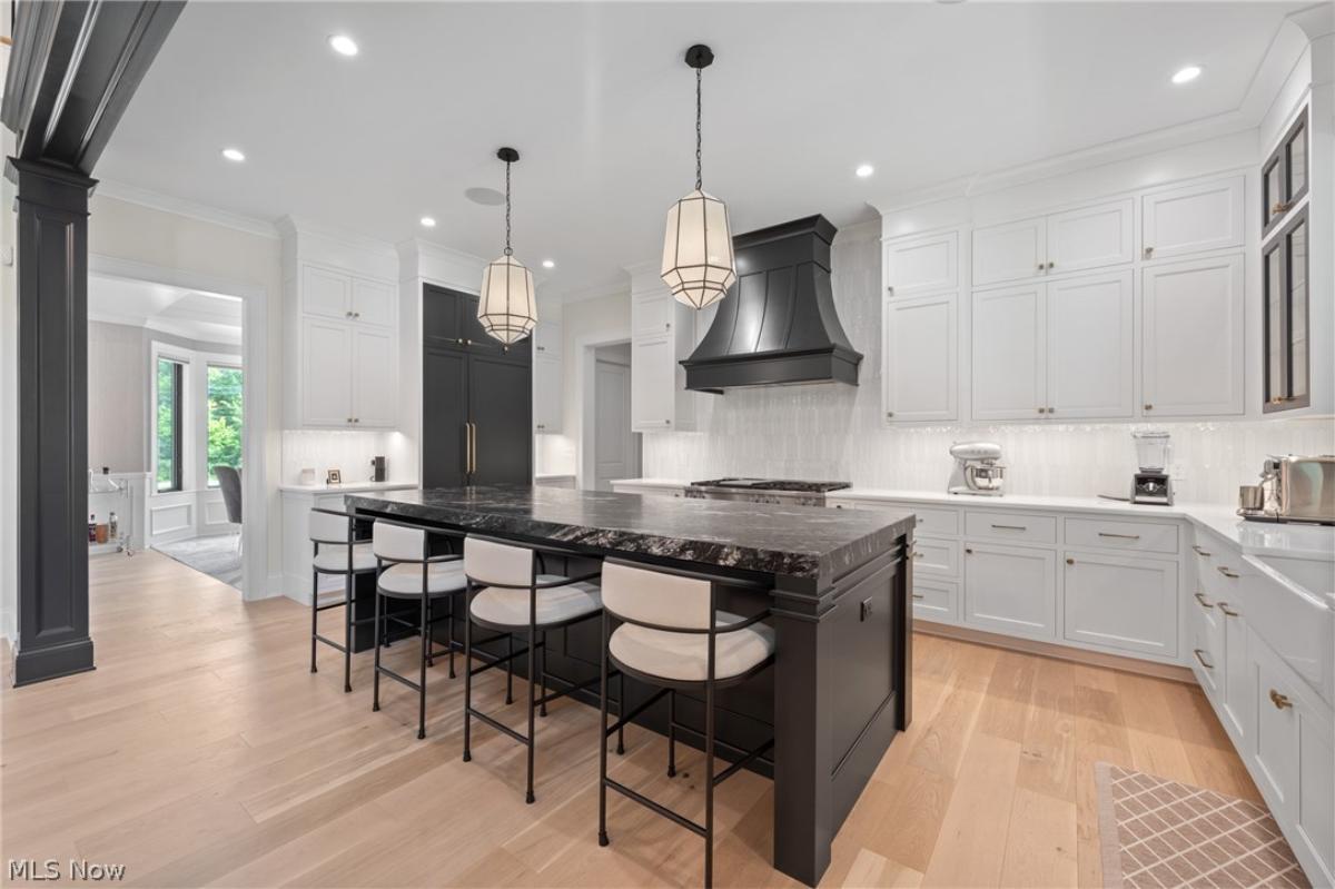 Kitchen with custom cabinetry and a counter breakfast bar.