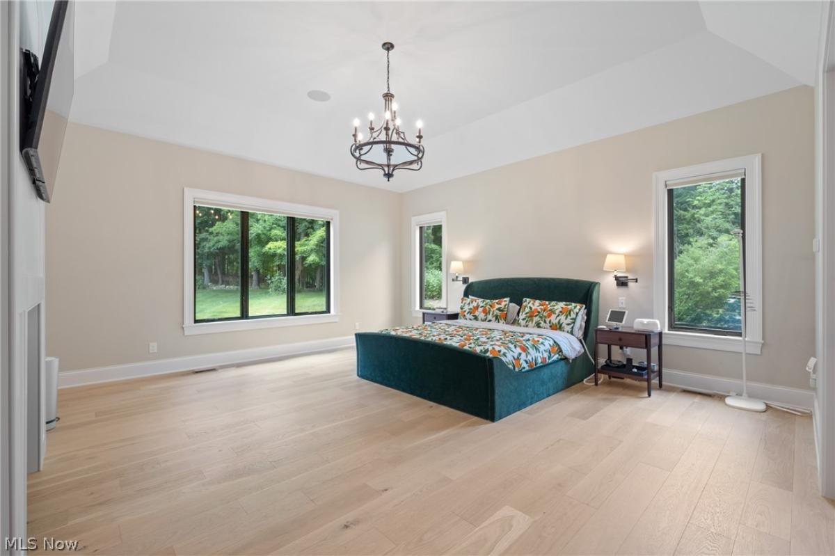 Bedroom with hardwood floors and glass windows.