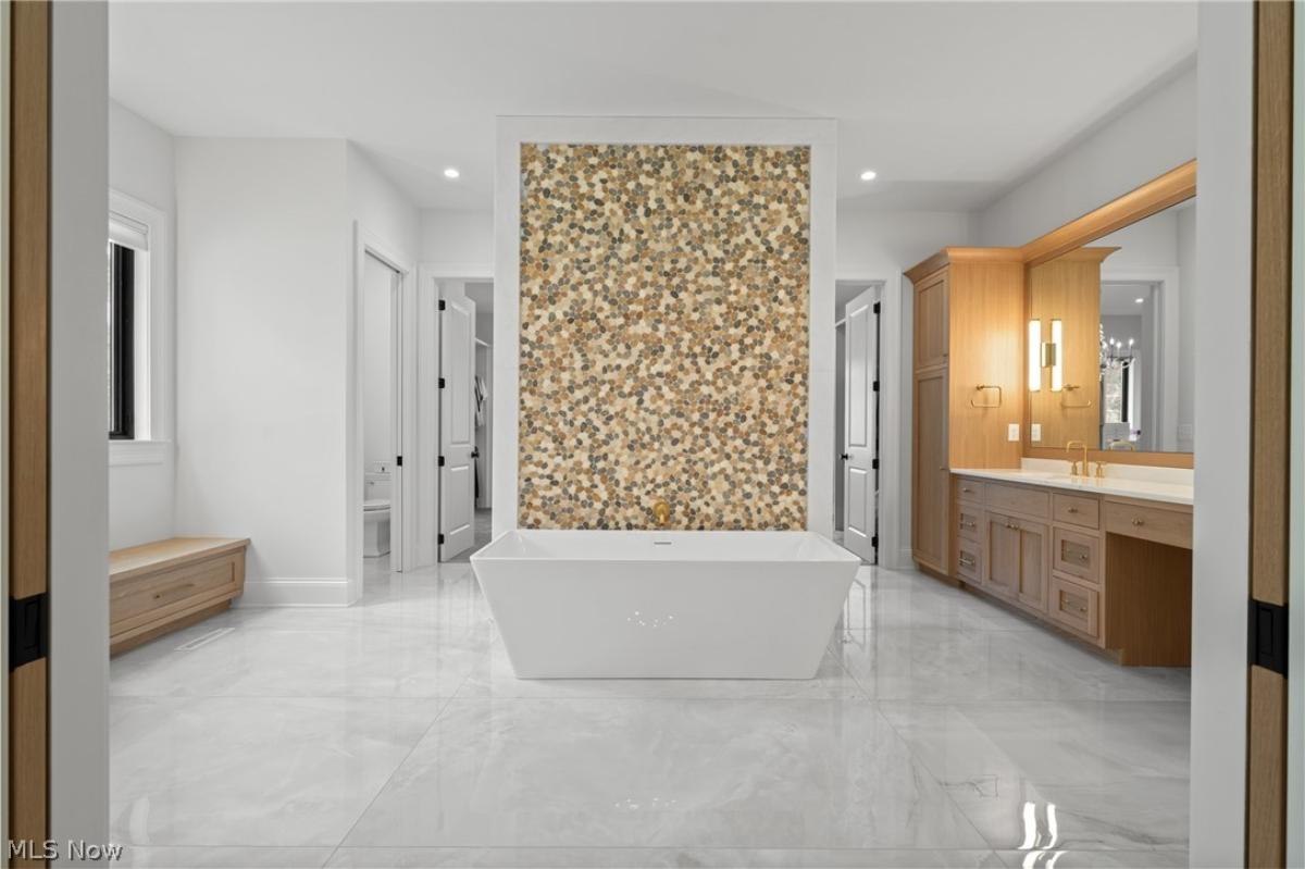 Bathroom with a custom-made vanity and a soaking tub.