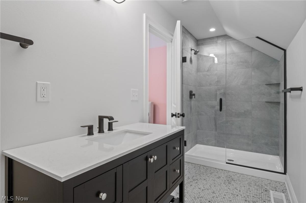 Bathroom with a sink and a walk-in shower.