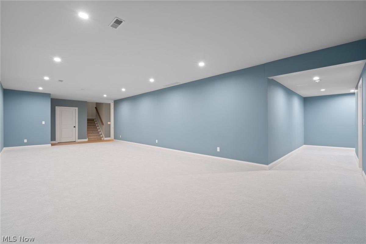 Recreation room with carpet flooring.