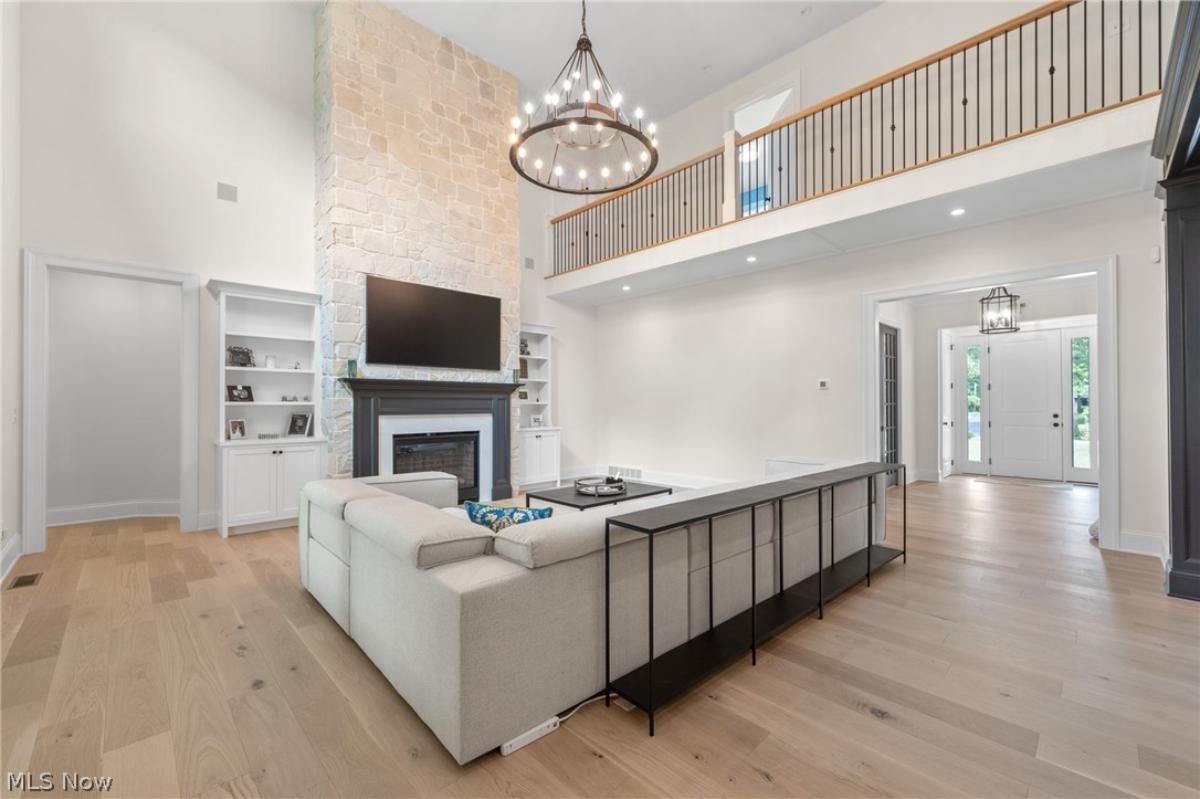 Living room with a fireplace and hardwood floors.