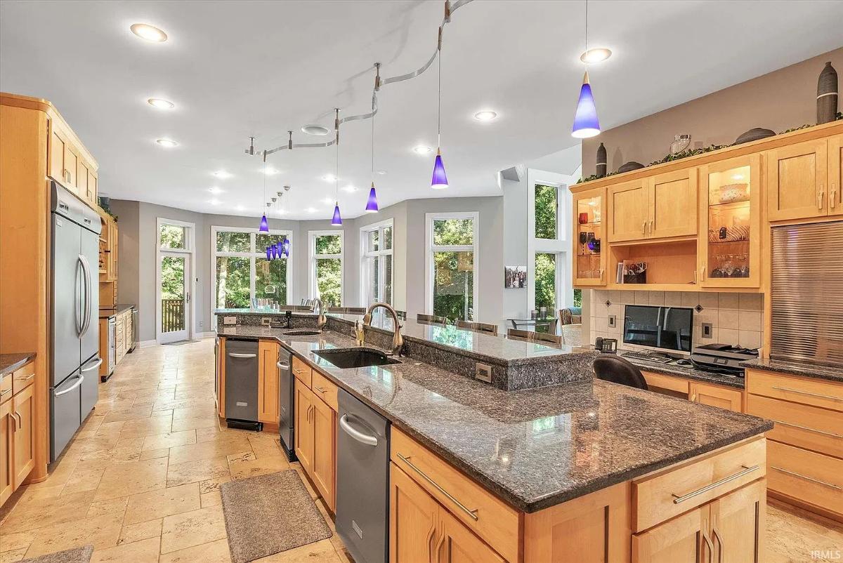Kitchen with custom cabinetry and a counter breakfast bar.