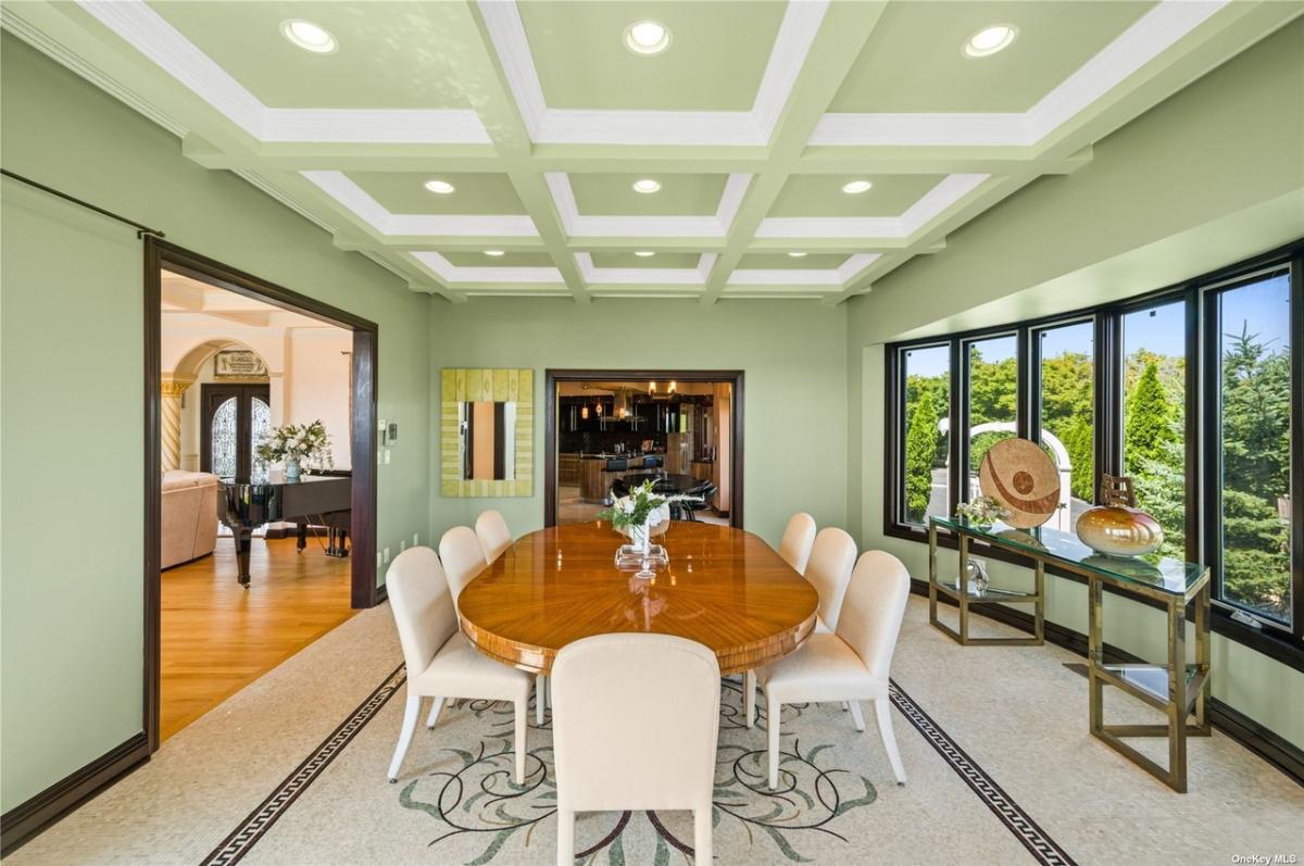 Dining room with coffered ceilings and a large wood table.