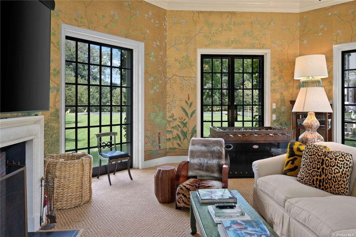 Living room with couches and a fireplace.