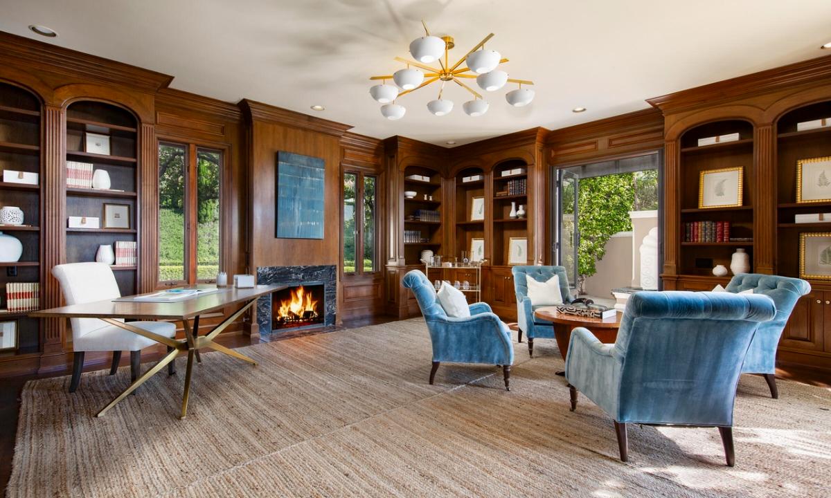 Home office with a fireplace.