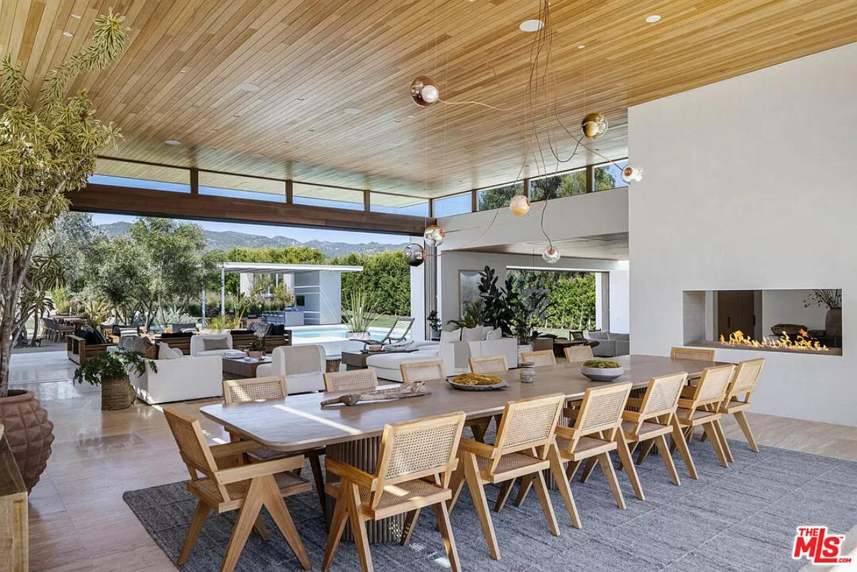 Dining room with a large wood table and a fireplace.