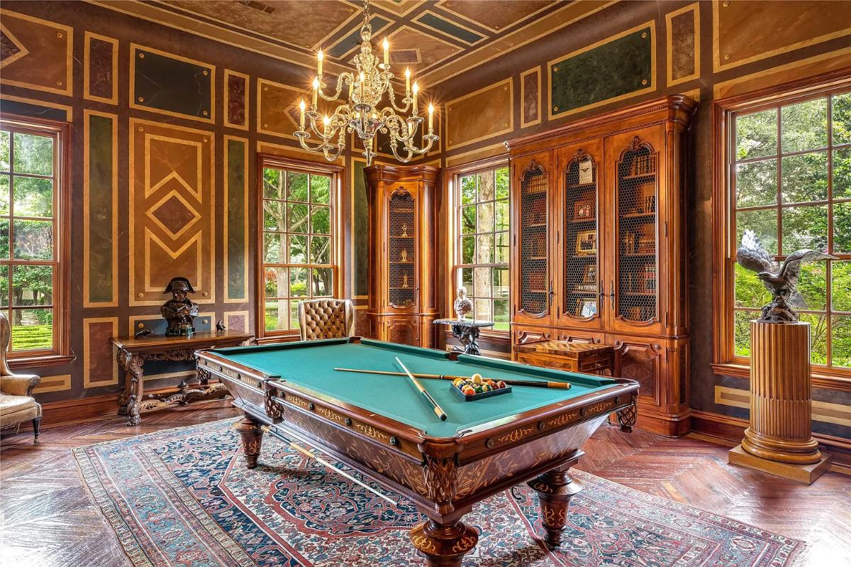 Billiards room with a chandelier.