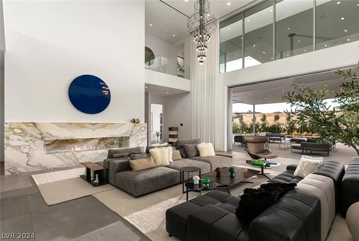 Living room with couches and a fireplace.