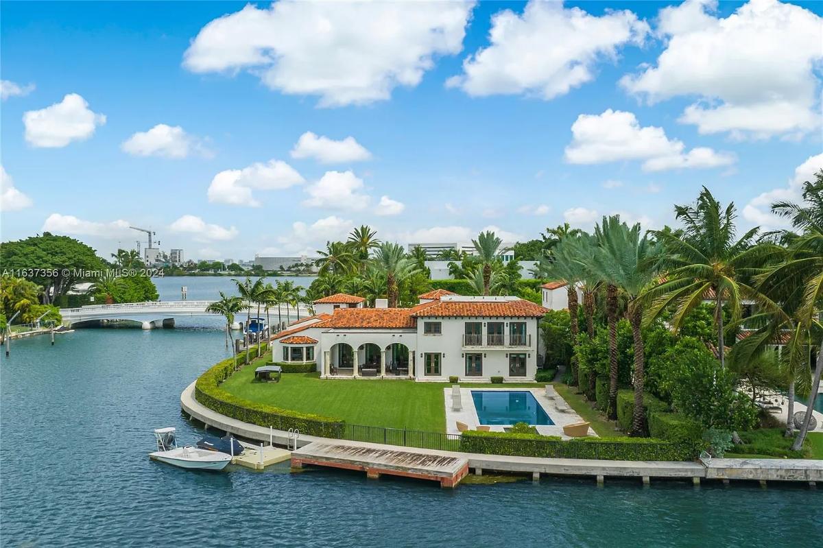 Aerial view of the mansion with a pool.