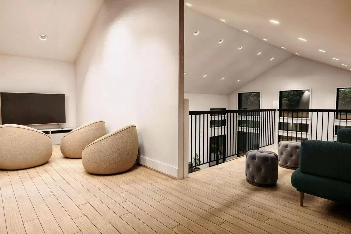 Loft with a large TV and round chairs over the wide plank flooring.
