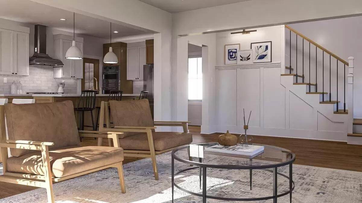 Living room showcasing the cushioned chairs and a round coffee table over the distressed area rug.