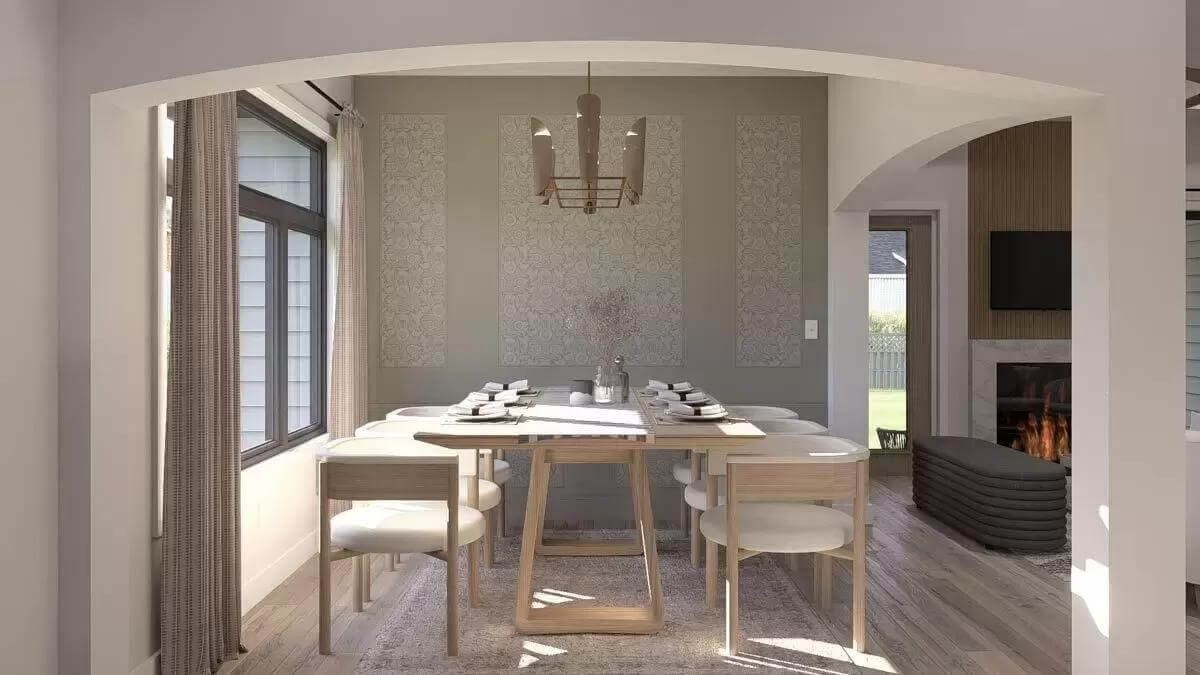 Dining room with a light wood dining set and an arched opening.