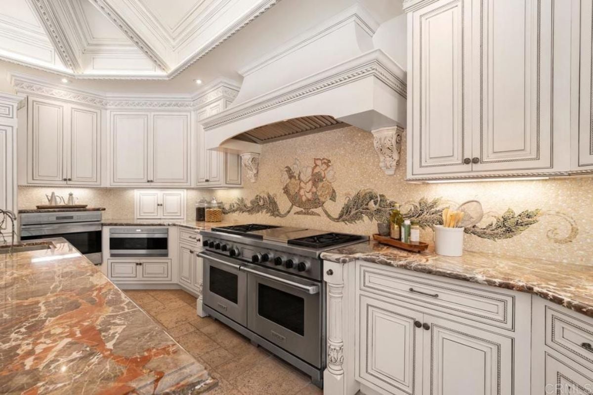 A kitchen with countertops, cabinets, and kitchen appliances.