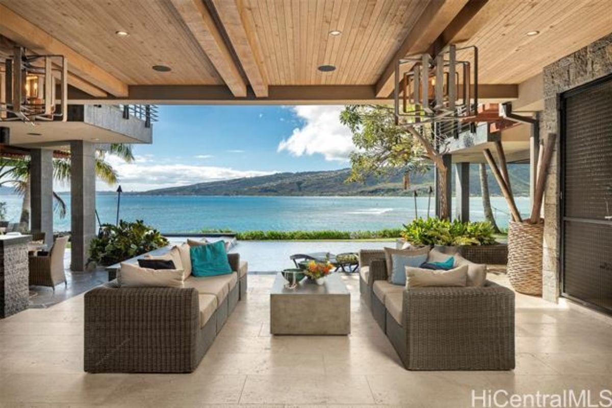 An outdoor living space with couches and a center table.