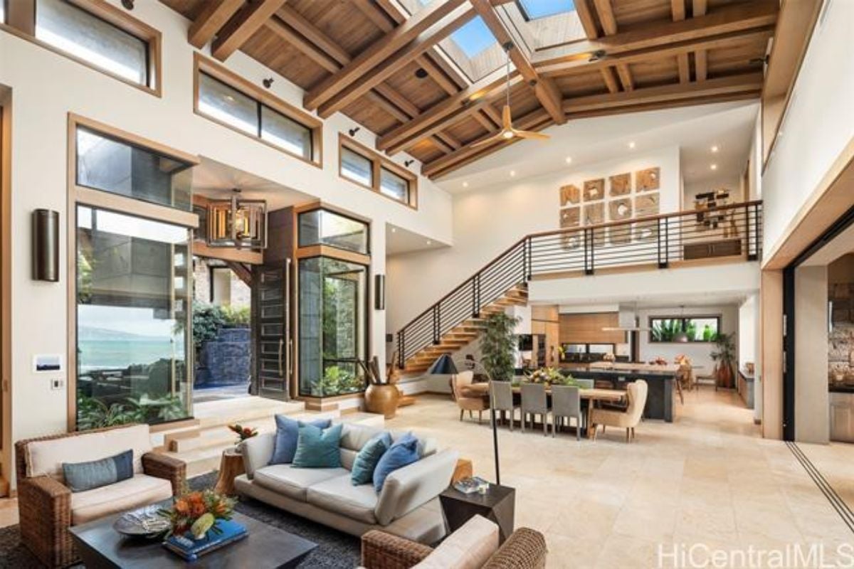 A great room with sunlight roofing, living area, dining area, and kitchen.