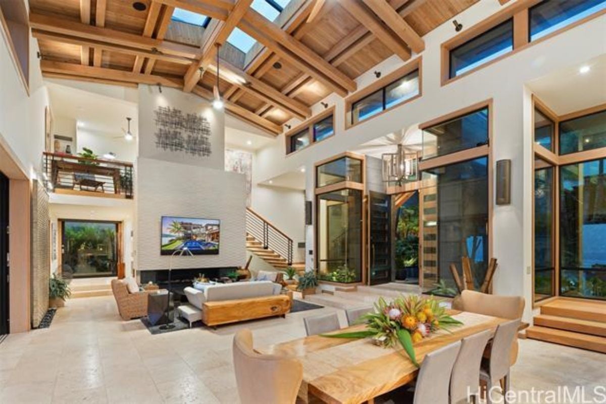 A great room with sunlight roofing, living area, and dining area.