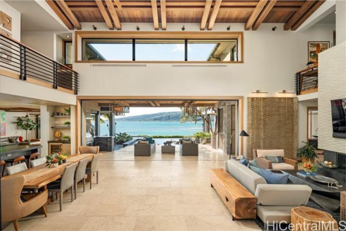 A great room with sunlight roofing, living area, dining area, and kitchen.