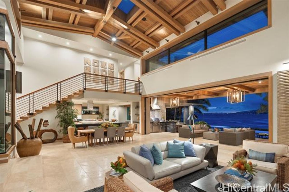 A great room with sunlight roofing, living area, dining area, and kitchen.