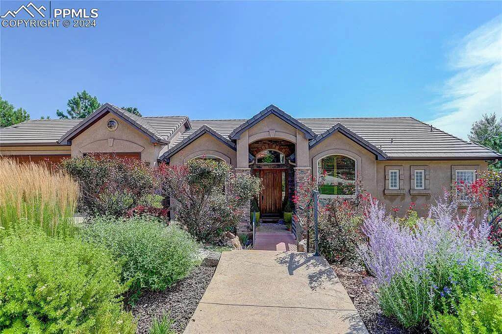Front view with gable rooflines, arched windows, and a covered entry.