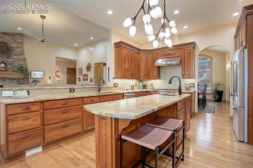 The kitchen includes a center island fitted with a prep sink.