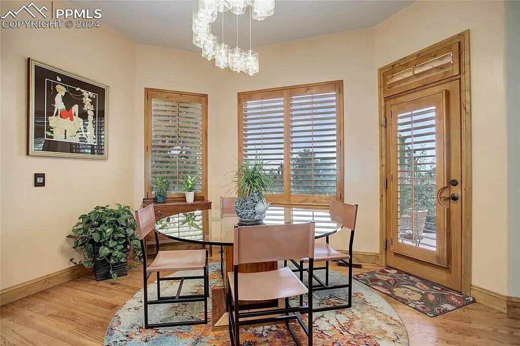 Breakfast nook with a round dining set against the bay window.