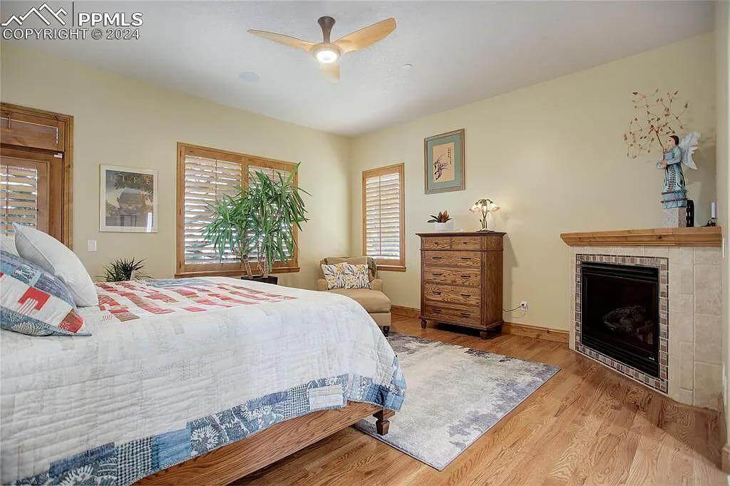 Primary bedroom with wooden furnishings and a corner fireplace.