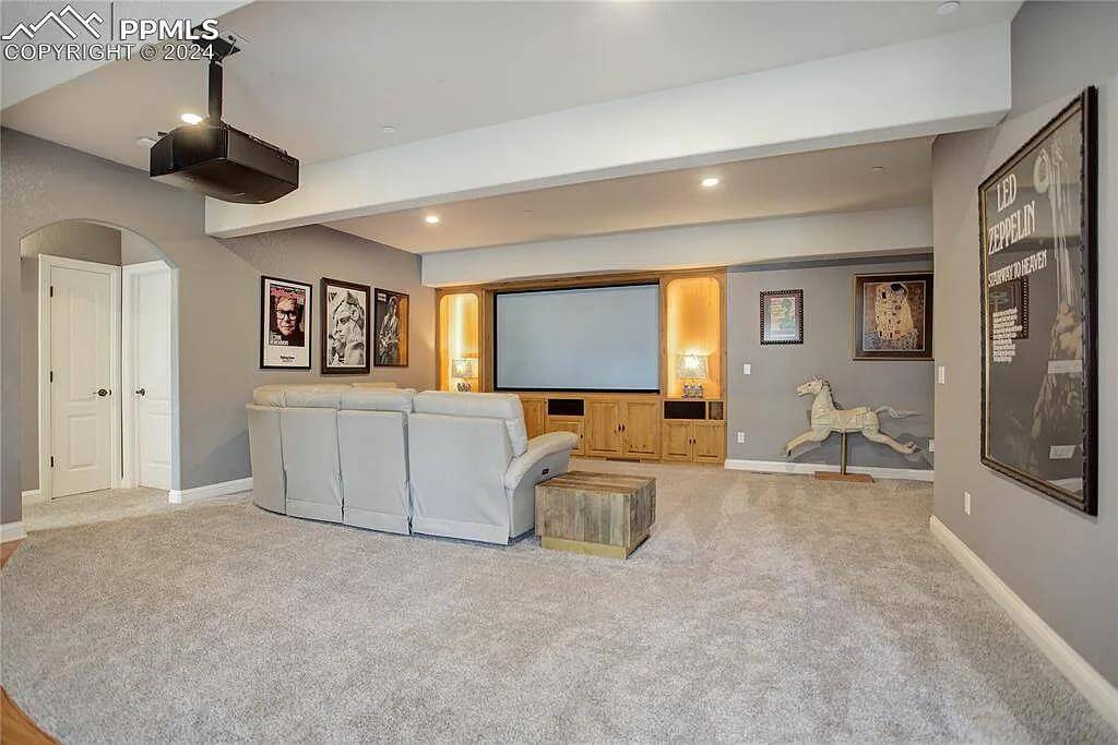 Media room with gray walls and a carpeted floor.