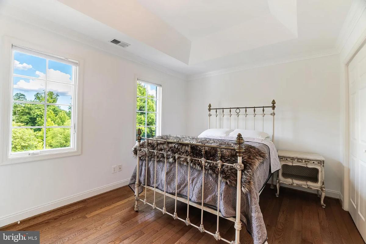 Bedroom with hardwood floors and glass windows.