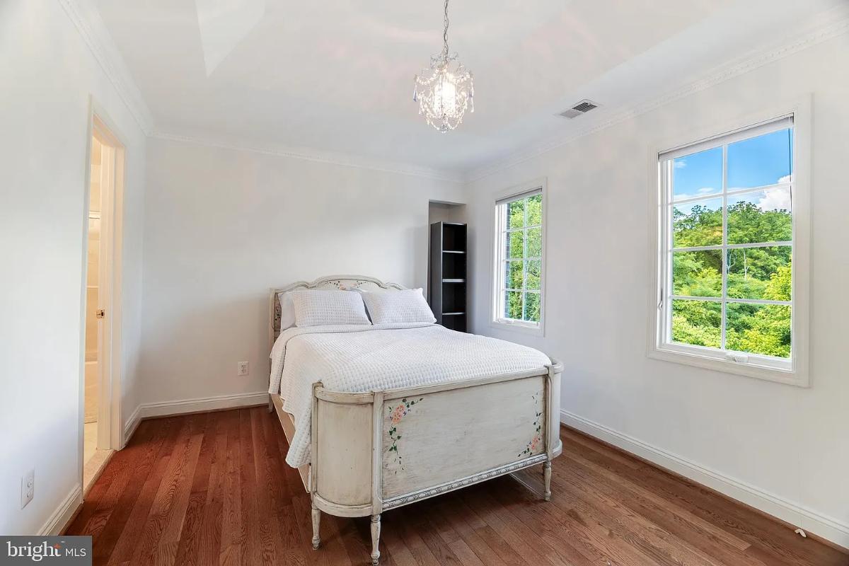 Bedroom with hardwood floors and glass windows.