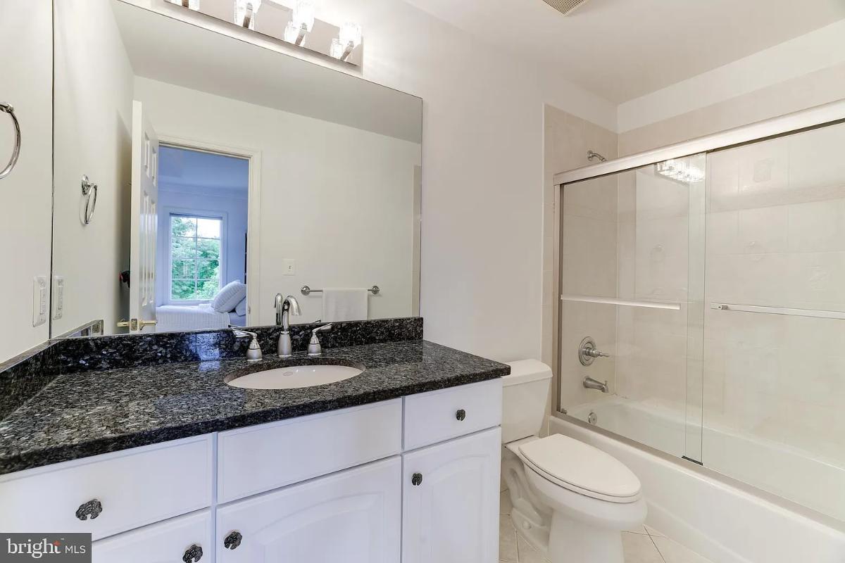 Bathroom with a sink, toilet and a shower.