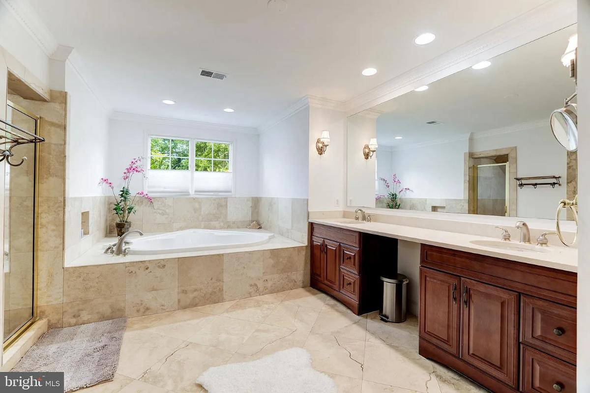Bathroom with a sink, a soaking tub and a walk-in shower.
