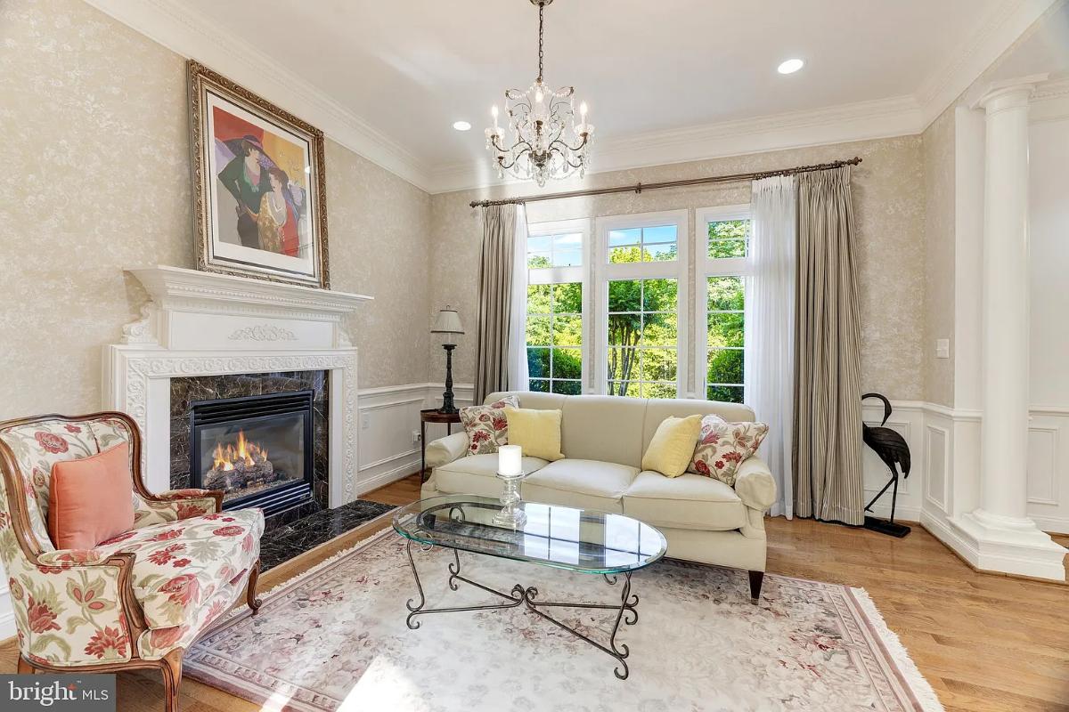 Living room with a chandelier and a fireplace.