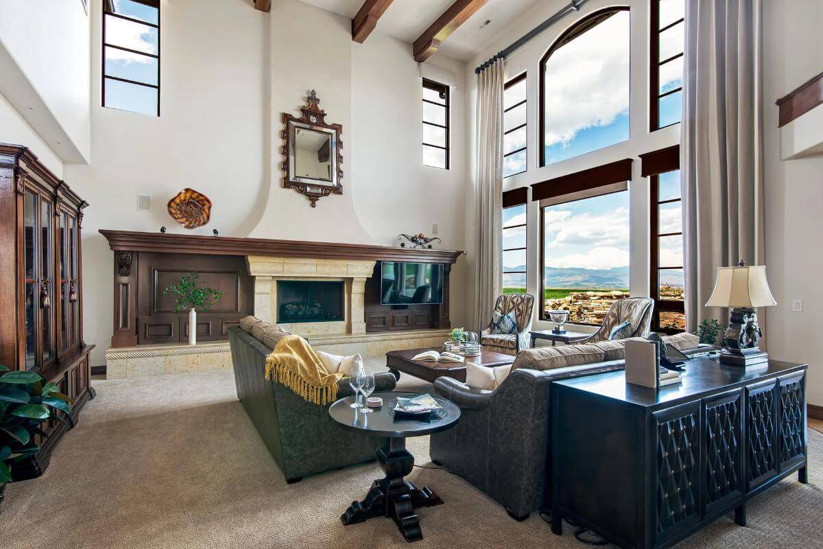 The living room includes a wall-mounted TV and a fireplace.
