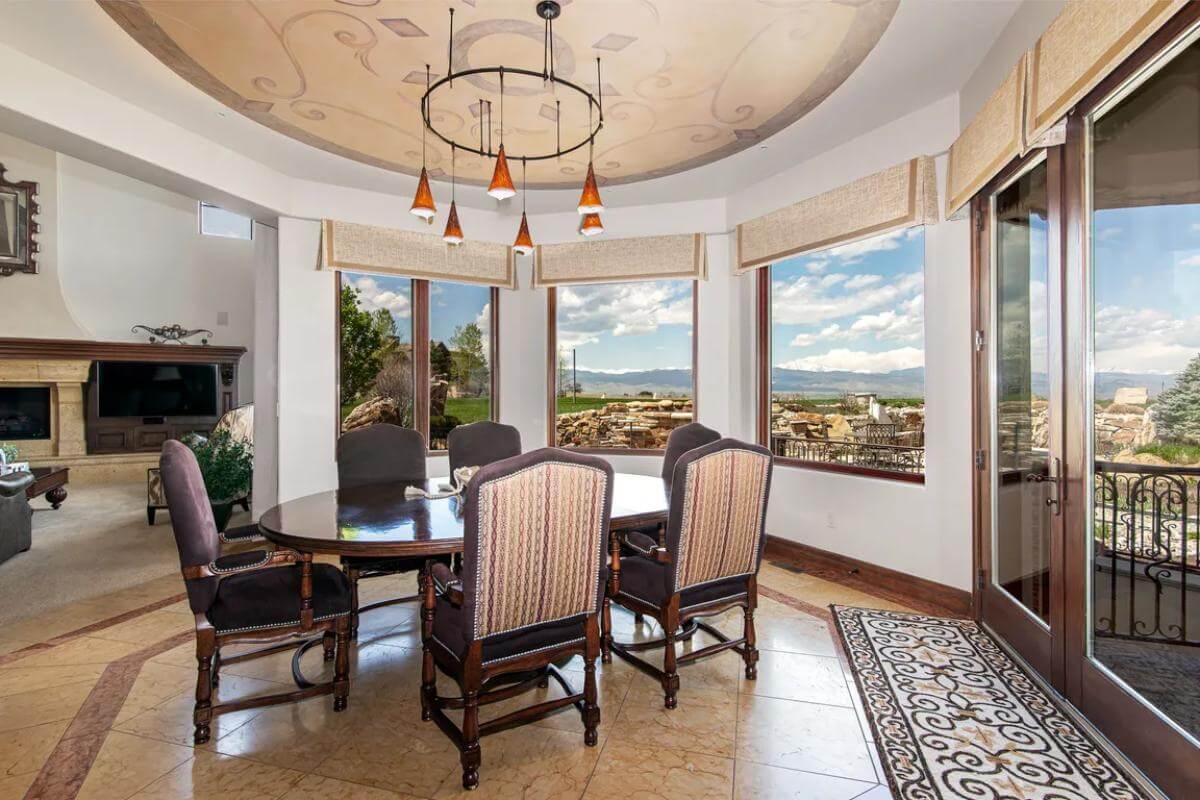 Breakfast nook a round dining set and a French door that opens to a covered porch.