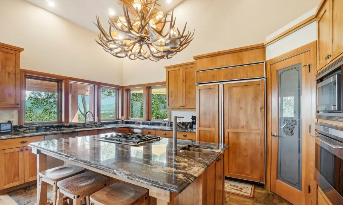 Kitchen with custom cabinetry, a counter breakfast bar and stainless-steel appliances.