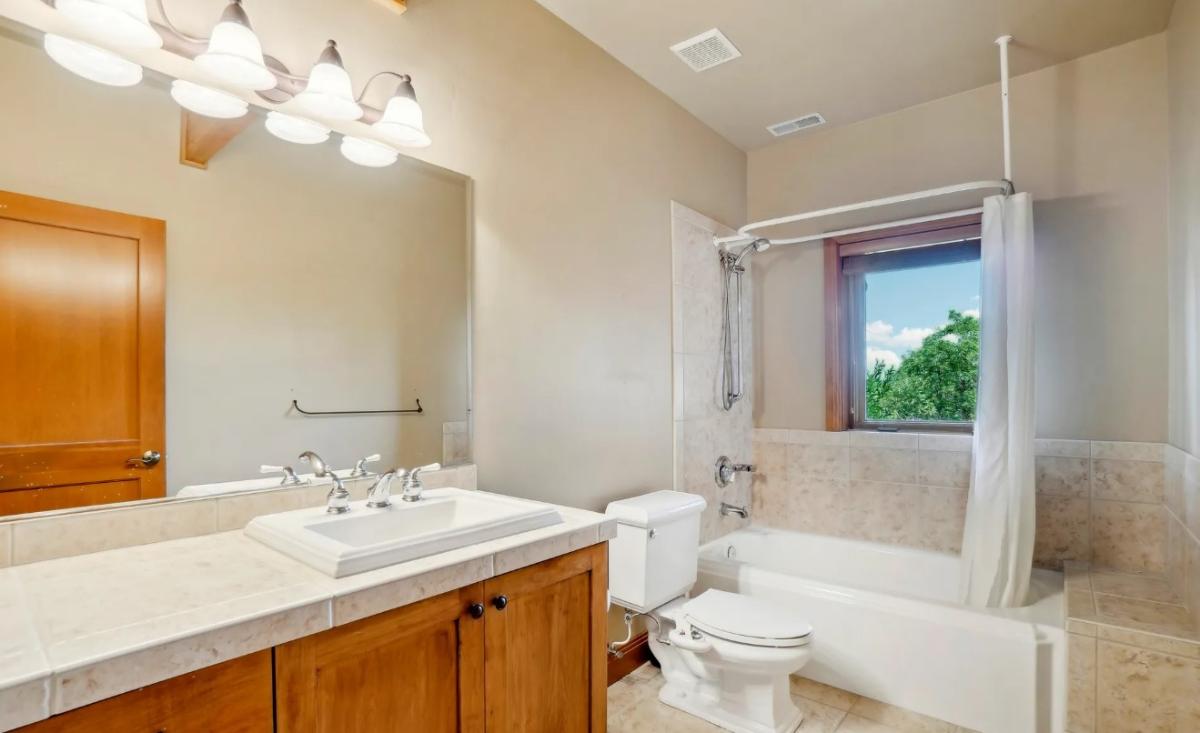 Bathroom with a sink, toilet and a shower.